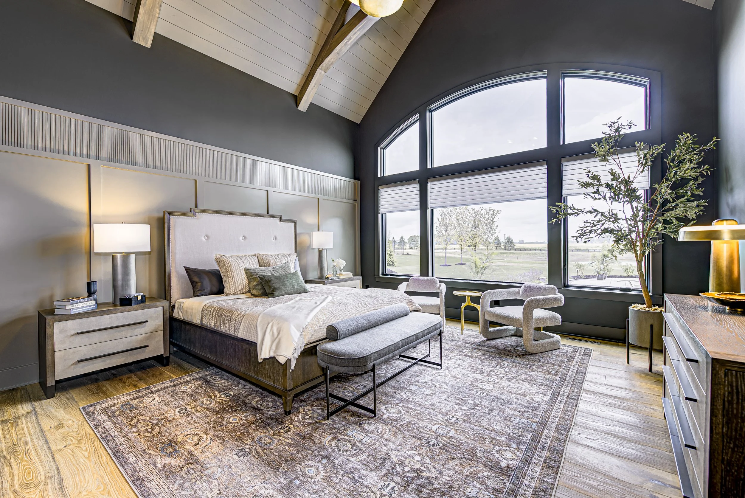 Primary bedroom suite with layered natural materials and soft lighting