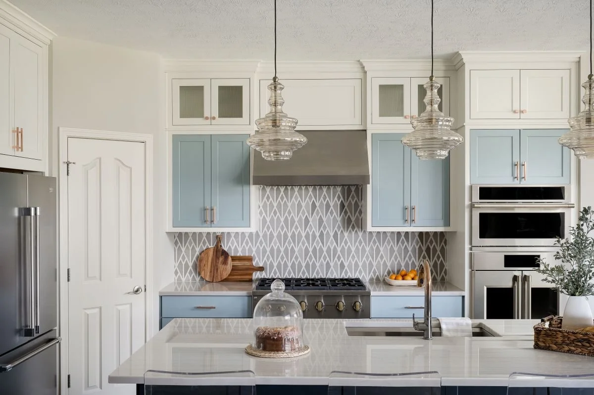 Luxury kitchen remodel in Fishers with a marble island and pale cabinetry